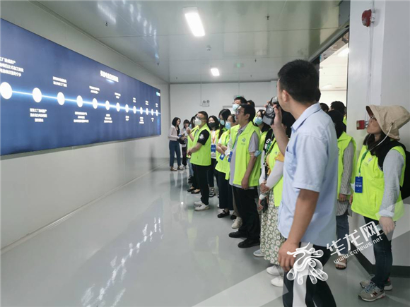 现场工作人员给记者介绍弗迪电池发展历程。华龙网-新重庆客户端 王钰 摄